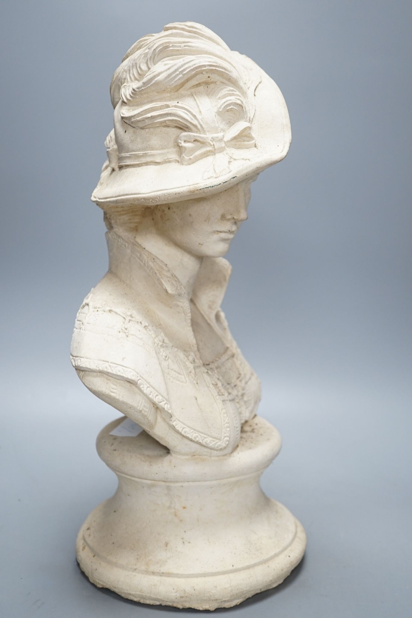 A composition bust of a 19th century lady in feather hat, 47 cms high.